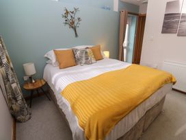 A bedroom with a bed and nightstand at Blake Lodge in Crantock