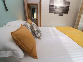 A bedroom with a bed and decorative pillows at Blake Lodge in Crantock
