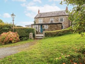 A house with a pathway and lamp post at Tresarrett Manor in Bodmin