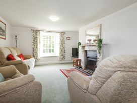 A living room with a fireplace and sofa at Tresarrett Manor in Bodmin
