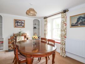 A dining room with a wooden table and chairs at Tresarrett Manor in Bodmin
