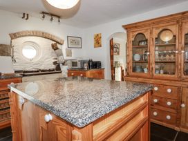 A kitchen with a granite countertop and appliances at Tresarrett Manor in Bodmin