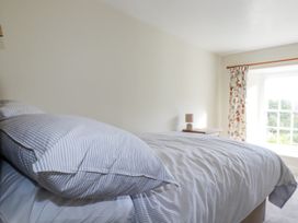 A bedroom with a bed and window at Tresarrett Manor in Bodmin