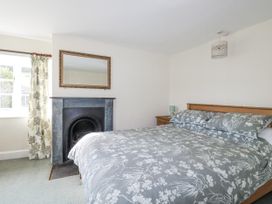A bedroom with a bed and fireplace at Tresarrett Manor in Bodmin