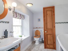 A bathroom with a sink, toilet, and bathtub at Tresarrett Manor in Bodmin