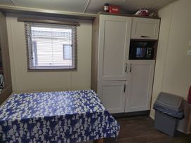 A kitchen with a table and microwave at 237 - Penkalick in Padstow