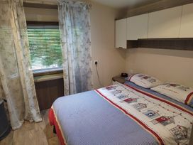 A bedroom with a bed and window at 237 - Penkalick in Padstow