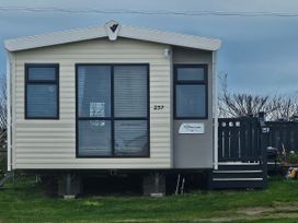 A mobile home exterior with windows and steps at 237 Haryn Sands Holiday Park in Padstow