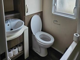 A bathroom with a toilet and sink at 237 Haryn Sands Holiday Park, Padstow