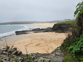 A beach with sand, water and rocks at 237 Haryn Sands Holiday Park Padstow