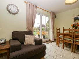 A dining room with a table and chairs at Orchard Cottage in Corse near Gloucester