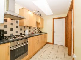 A kitchen with cabinets and a gas stove at Orchard Cottage Corse near Gloucester