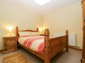 A bedroom with a bed and nightstand at Orchard Cottage in Corse near Gloucester