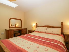 A bedroom with a bed and dresser at Orchard Cottage Corse near Gloucester