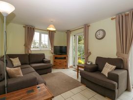 A living room with a sofa and television at Orchard Cottage Corse near Gloucester