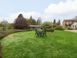A garden with a table and chairs at Orchard Cottage Corse near Gloucester