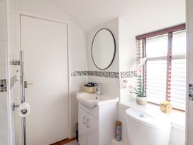 A bathroom with a sink and toilet at Periwinkle Cottage in Conwy