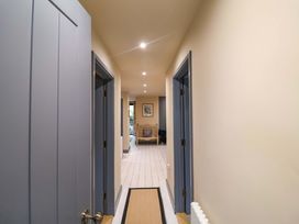 A hallway with doors and a radiator at 52 Lee Road, Aldeburgh