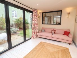 A living room with a sofa and sliding glass door at 52 Lee Road Aldeburgh
