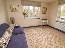 A snug with a sofa and table at 52 Lee Road Aldeburgh