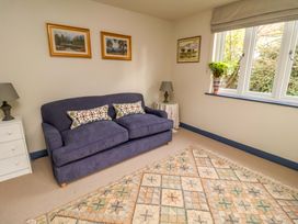 A living room with a sofa and paintings at 52 Lee Road in Aldeburgh