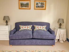 A living room with a sofa and paintings at 52 Lee Road Aldeburgh