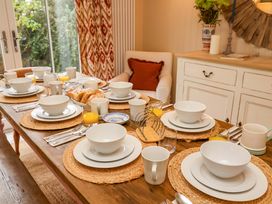 A dining room table set with dishes and drinks at 52 Lee Road Aldeburgh