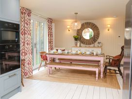 A dining room with a pink table and chairs at 52 Lee Road Aldeburgh