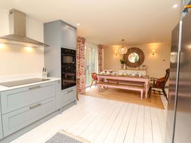 A kitchen with a dining area and appliances at 52 Lee Road Aldeburgh