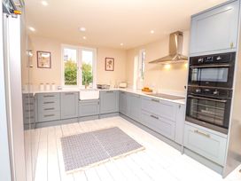 A kitchen with cabinets and appliances at 52 Lee Road, Aldeburgh