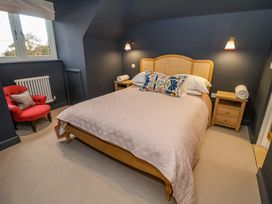 A bedroom with a bed and nightstand at 52 Lee Road in Aldeburgh