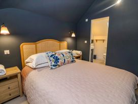 A bedroom with a bed and bedside table at 52 Lee Road in Aldeburgh