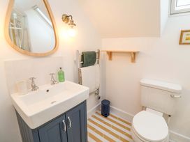A bathroom with a sink, toilet, and towel rack at 52 Lee Road, Aldeburgh
