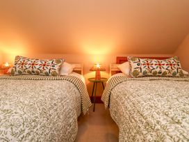 A bedroom with two beds and lamps on the bedside table at 52 Lee Road, Aldeburgh