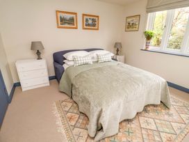 A bedroom with a bed and nightstand at 52 Lee Road, Aldeburgh