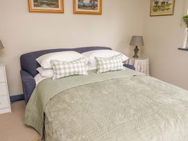 A bedroom with a bed and side table at 52 Lee Road in Aldeburgh