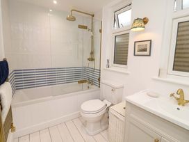 A bathroom with a shower and bathtub at 52 Lee Road in Aldeburgh