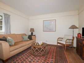 A living room with a sofa and coffee table at Copper Mine Cottage in Bodmin