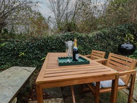 A table with champagne and glasses at Copper Mine Cottage in Bodmin