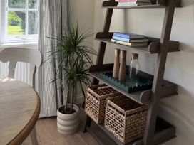 A dining room with shelves and a table at Copper Mine Cottage Trelill near Port Isaac