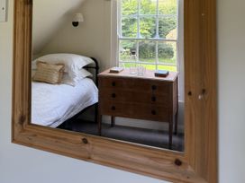 A bedroom with a bed and a chest of drawers at Copper Mine Cottage in Trelill near Port Isaac
