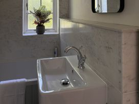 A sink with a faucet and plant at Copper Mine Cottage Trelill near Port Isaac