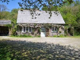 A house with a front door and windows at Copper Mine Cottage in Trelill near Port Isaac