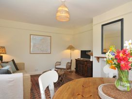 A living room with a sofa and coffee table at Copper Mine Cottage Trelill near Port Isaac
