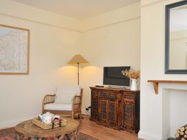 A living room with a television and a coffee table at Copper Mine Cottage in Trelill near Port Isaac