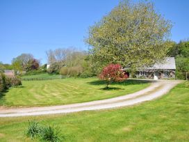 A house with a driveway and trees at Copper Mine Cottage, Trelill near Port Isaac