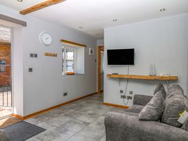 A living room with a sofa and television at The Milk Shed in Plymtree