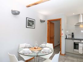 A dining area with a table set for four at The Milk Shed in Plymtree