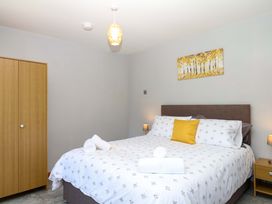 A bedroom with a bed and closet at The Milk Shed in Plymtree