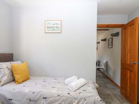 A bedroom with a bed and towels at The Milk Shed in Plymtree